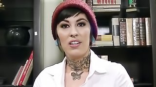 Inked schoolgirl strips and teases her tits and pussy in an office.